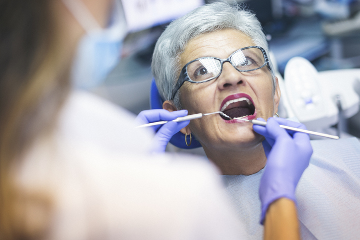 Older woman undergoing dental treatment